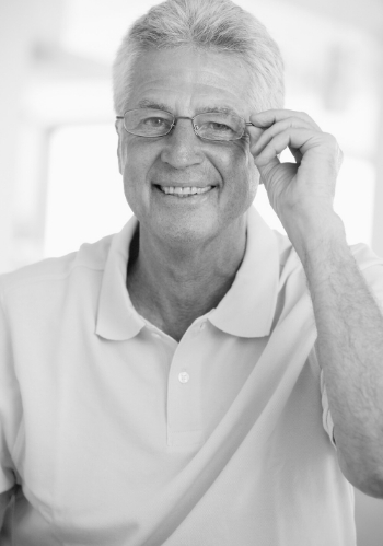older white man wearing glasses smiling at camera
